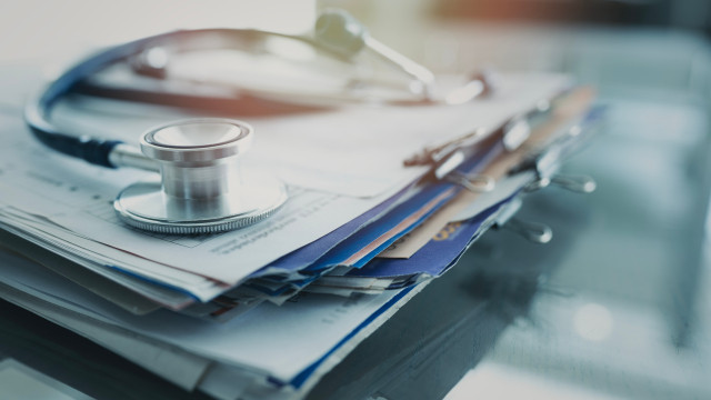 stethoscope on stack of papers